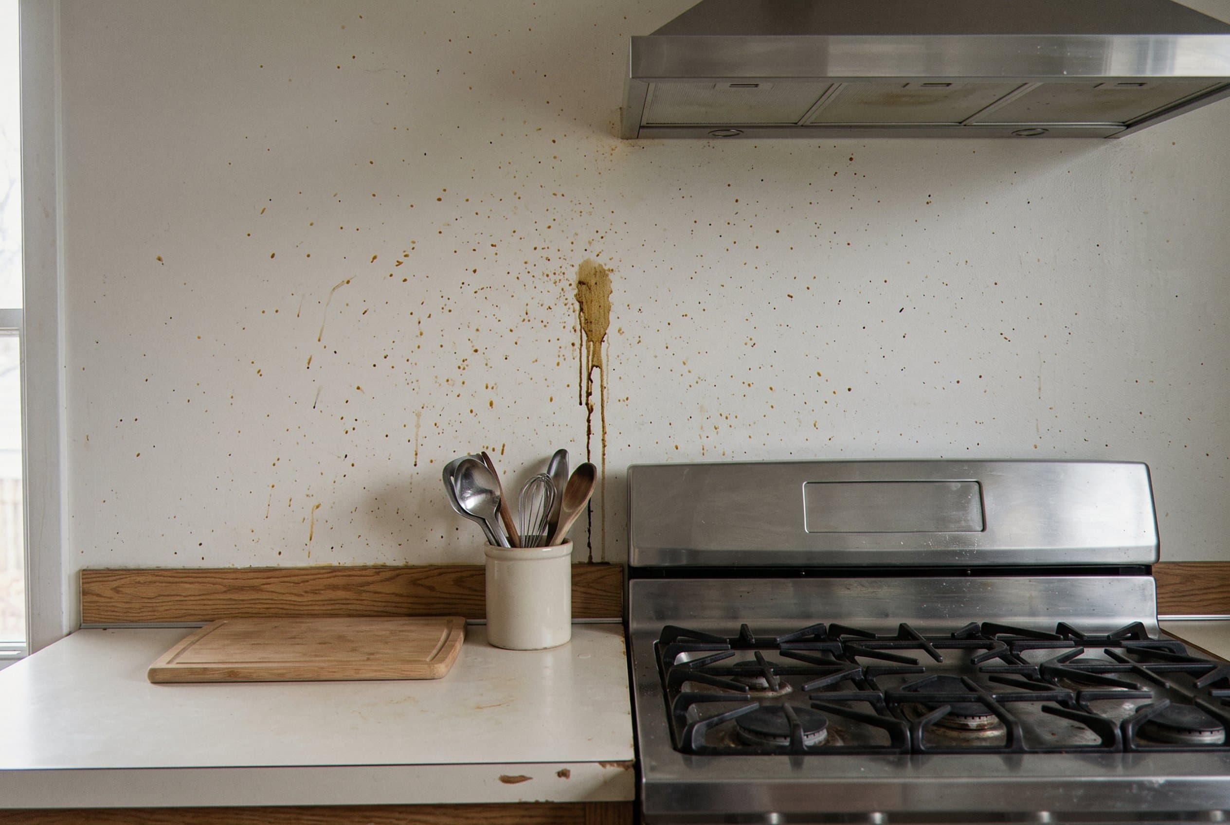 Stained kitchen wall behind the stove before backsplash