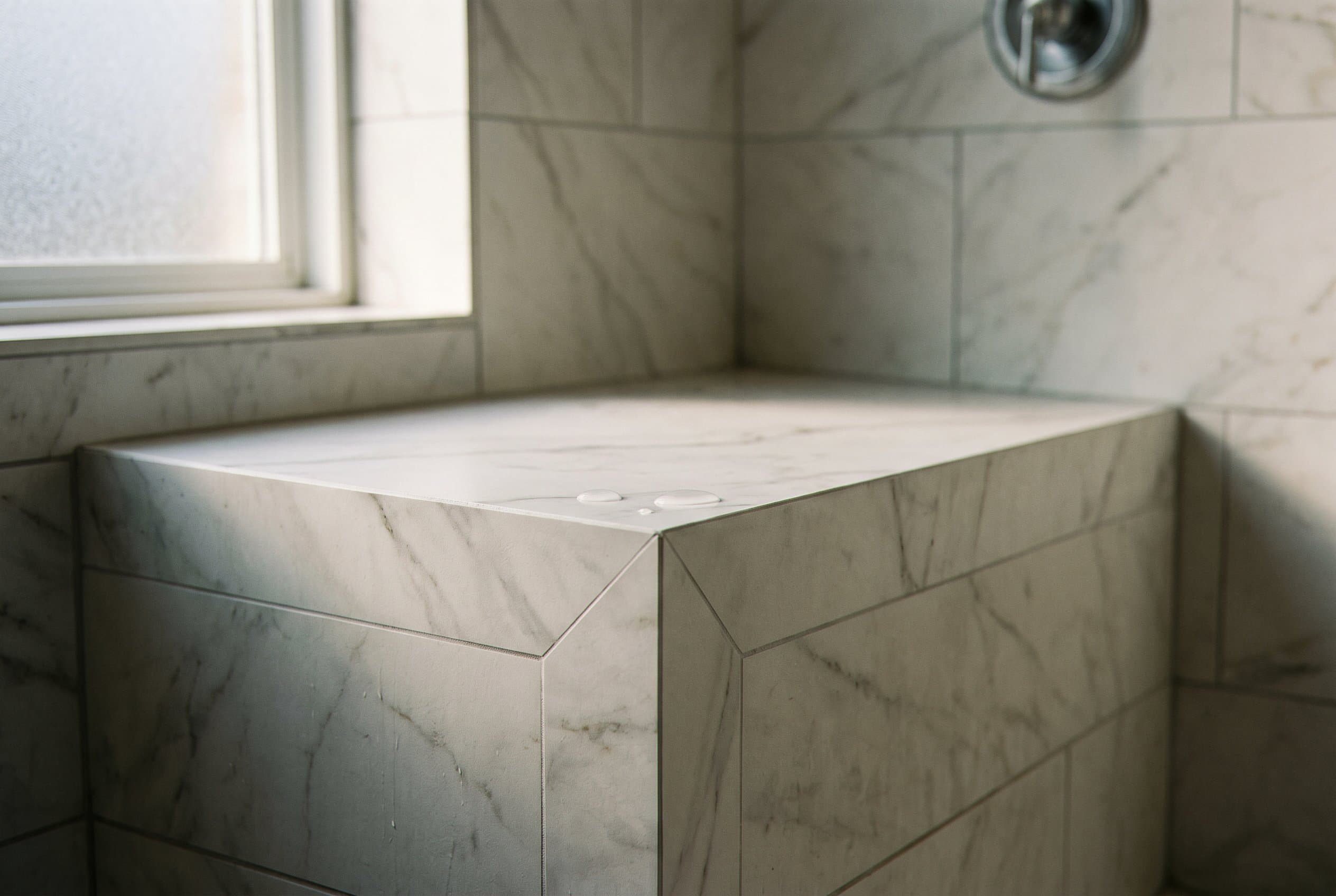 Mosaic tile shower pan sloped toward center drain